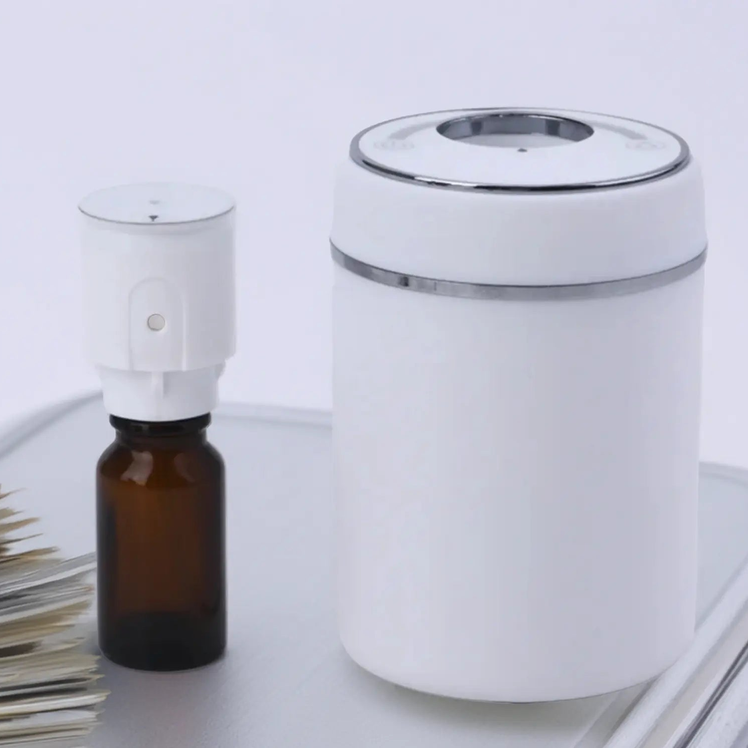 White Mini Electric Scent Diffuser showing the inside vessel to fill with purple duck room spray 