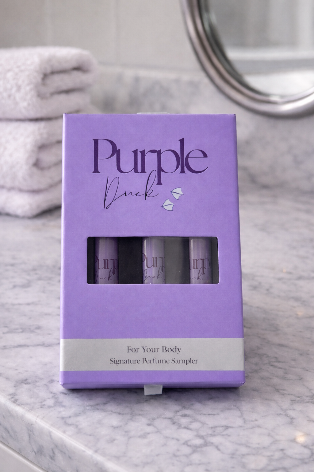 Purple Duck Clean Perfume Discovery Set sitting on a table 