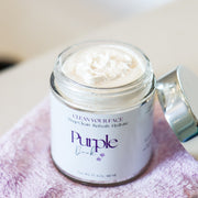 Jar of purple duck whipped facial cleanser with the lid open.