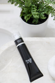 Purple Duck Goats Milk Men's Hand Lotion sitting on a white counter