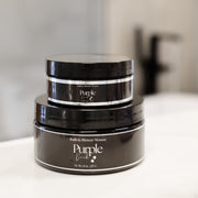 A stack of 2 oz and 8 oz Shower Mousse sitting on a bathroom counter