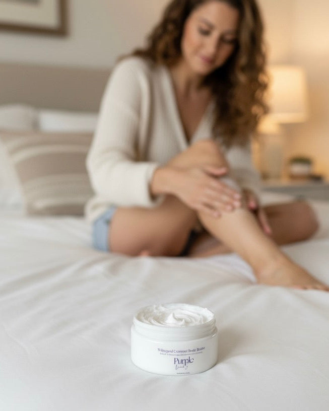 Woman applying purple duck body butter to her legs 