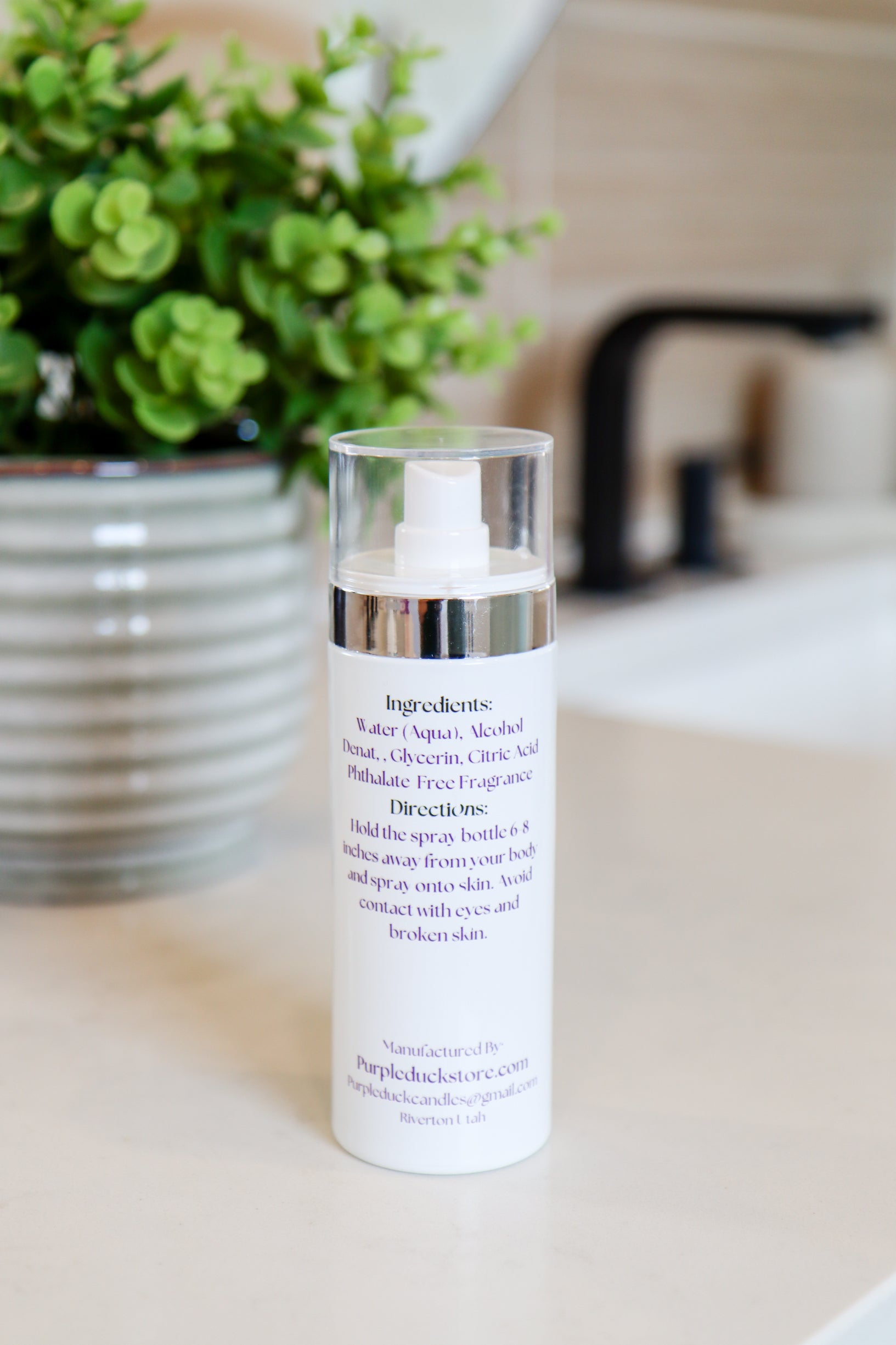 Back view of Purple Duck body spray bottle showing ingredients and usage instructions