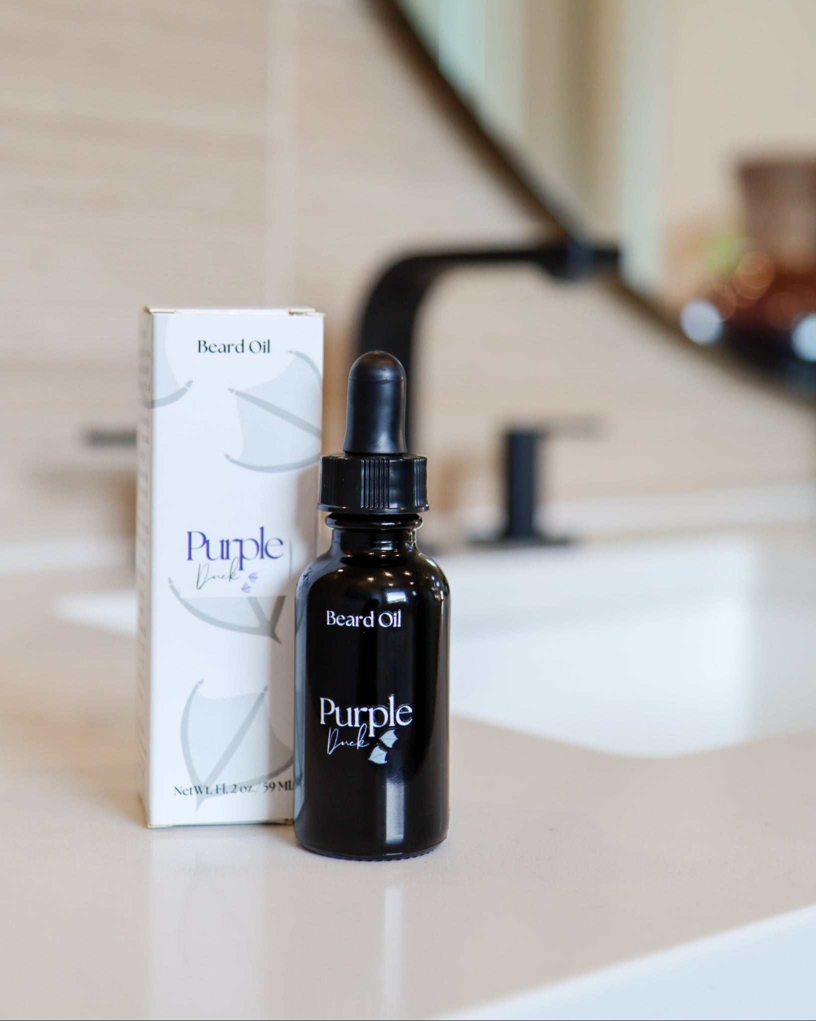 A bottle of Men's Natural Beard Oil with a dropper cap, displayed next to its packaging box on a bathroom counter.