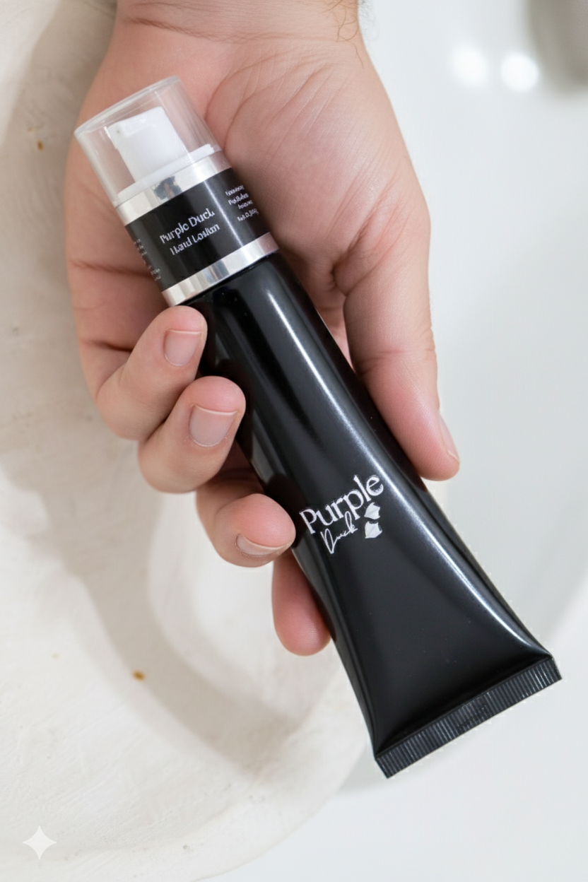 Hand holding a purple duck mens hand lotion on a white background