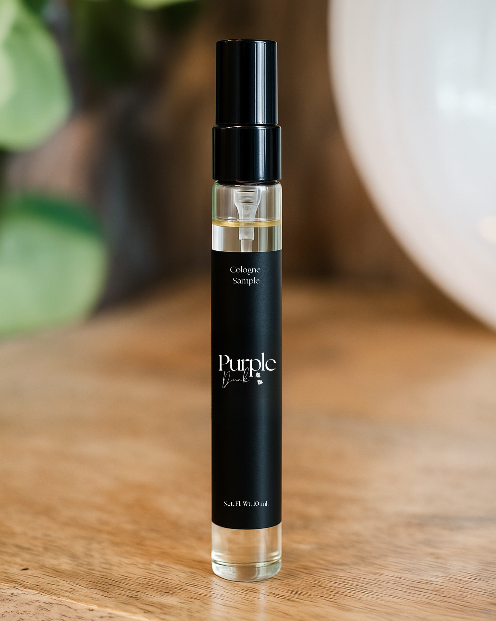 Cologne bottle labeled 'Purple Duck" on a wooden surface with blurred background