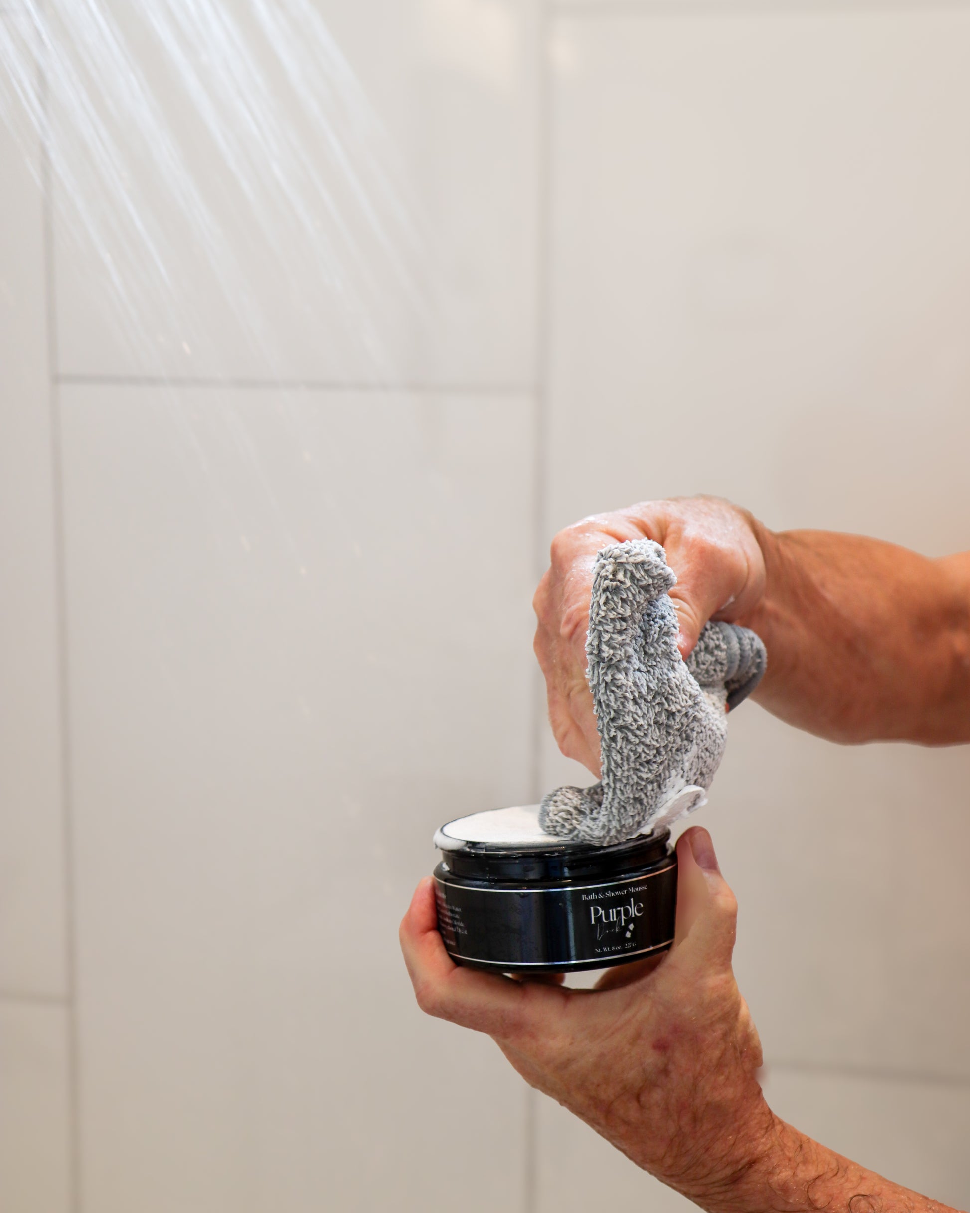 Purple Duck Shower Mousse being used in the shower